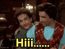 two men sitting next to each other with the word hiii on the screen