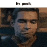 a close up of a man 's face with the words it 's peak above him