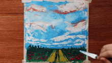 a painting of a road going through a field with a blue sky in the background