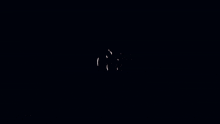 a candle is lit up in a dark room with a glowing e on it