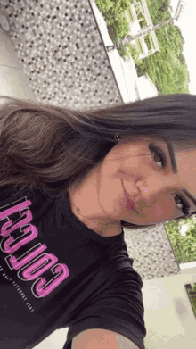 a woman is wearing a black shirt that says california