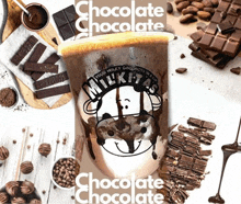 a milk tas chocolate milkshake surrounded by chocolate pieces
