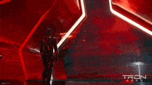 a tron ares poster with a man in a suit