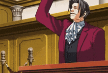 a man in a red suit stands at a podium with his arm up