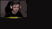 a man wearing headphones is sitting in a chair in a dark room .
