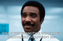 a man with a mustache is smiling and says visa v the diminutive weakling 's inexorably disappoint me .