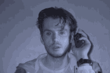 a man is talking on a cell phone in a dark room