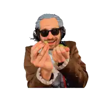a man wearing headphones and sunglasses is holding a kiwi