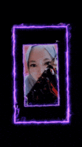a woman in a hijab is surrounded by a purple glowing frame
