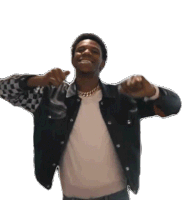 a man wearing a denim jacket and a white shirt points at the camera