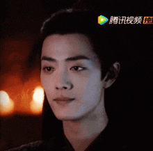 a close up of a man 's face with chinese characters on the bottom