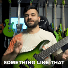 a man playing a green guitar with the words something like that behind him