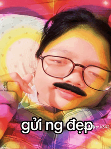 a girl wearing glasses and a fake mustache has gui ng dep written on her face