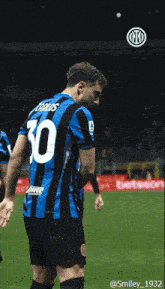 a soccer player wearing a number 10 jersey stands on the field