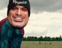 a man wearing a beanie that says blizzard x