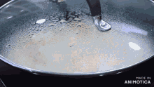 a pan with a glass lid is being made in animatica