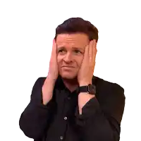 a man wearing a watch is making a surprised face with his hands on his face