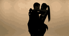 a man is carrying a woman in his arms
