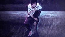 a man is sitting on a chair in a field with his legs crossed .