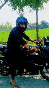 a man wearing a helmet sits on a motorcycle