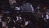 a blurry picture of a crowd of people sitting in a stadium