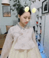 a woman wearing a white dress with a cat face on her head