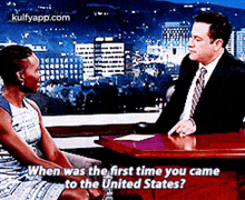 a man and a woman are sitting at a table talking about when was the first time they came to the united states .