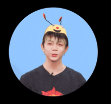 a man wearing a bee hat and a sun shirt