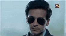 a close up of a man wearing sunglasses with a sony television logo in the corner
