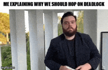 a man with a beard is explaining why we should hop on dea clock