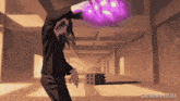 a gif from gifrun.com shows a person holding a purple object in their hand