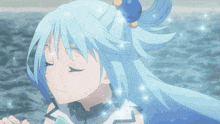 a girl with blue hair is smiling with her eyes closed in front of a body of water