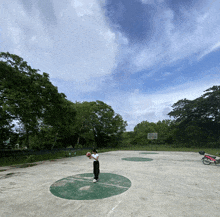 a person is playing basketball on a court with a basketball hoop in the background
