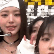 a group of young women are standing next to each other and talking into microphones .