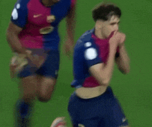 a soccer player with the number 2 on his shorts stands on the field