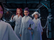 three women in bathrobes are standing next to each other in a room