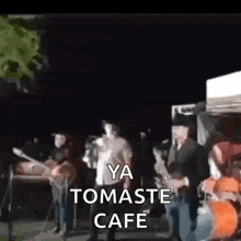 a blurry picture of a group of people playing instruments with the words ya tomaste cafe written in the corner .