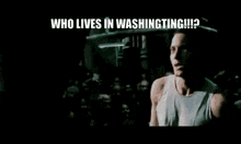 a man is singing into a microphone in front of a crowd and the words `` who lives in washington ? ''