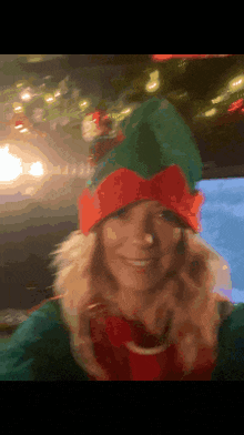 a woman is dressed as an elf and smiling