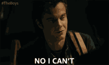 a man says no i can 't in front of a #theboys logo