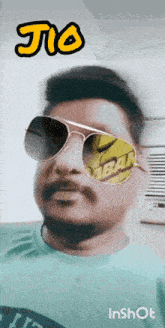 a man wearing sunglasses with the word jio written above him