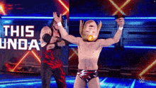 two wrestlers on a stage with the words this unda