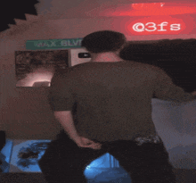 a man is dancing in front of a sign that says max blv
