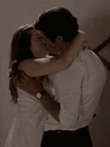 a man and a woman are kissing and hugging each other