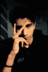 a blurry picture of a man making a peace sign with his fingers