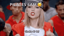 a woman wearing a beanie and a red jacket says pilates 6 am shake it off