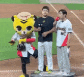 a man in a tigers mc jersey is standing next to a mascot