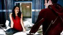 a woman in a red dress is standing next to a man in a red jacket who says yeah yeah