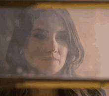 a close up of a woman 's face behind a glass