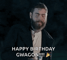 a man with a beard is holding a gun and saying happy birthday gwagon !!!